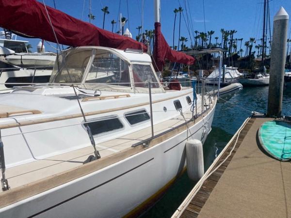 Slide: The Image of 1978 Gulfstar 50 sailboat docked at marina with red sails. - 9