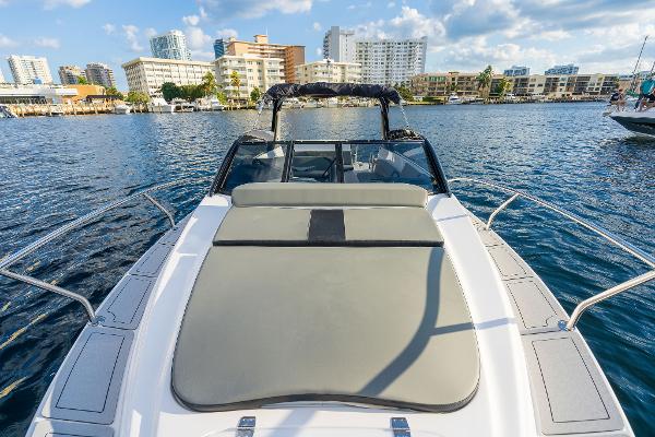 Slide: The Image of 2025 Hanover 305 boat on water with city skyline in background. - 2
