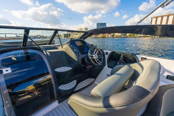 Slide: The Image of Luxurious Hanover 305 boat interior, 2025 model, with sleek dashboard and waterfront view. - 3