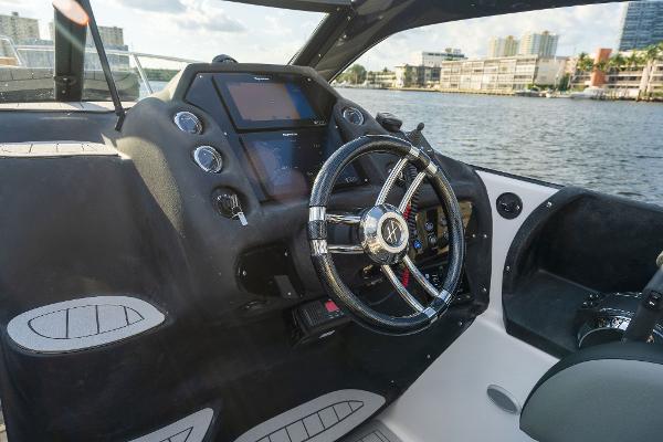Slide: The Image of Helm of 2025 Hanover 305 boat with modern controls and waterfront view. - 4