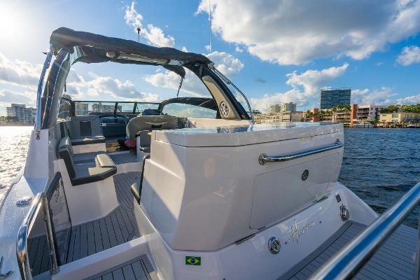 Slide: The Image of Modern Hanover 305 yacht on water, sunny day, city skyline in background, 2025 model. - 7