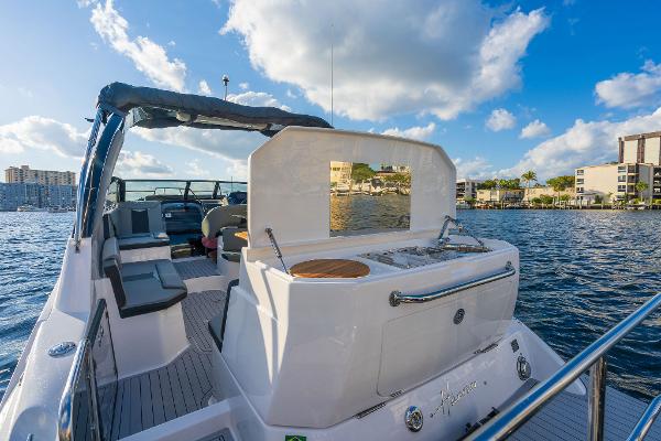 Slide: The Image of Luxury Hanover 305 boat, 2025 model, cruising on a sunny day with clear skies. - 8