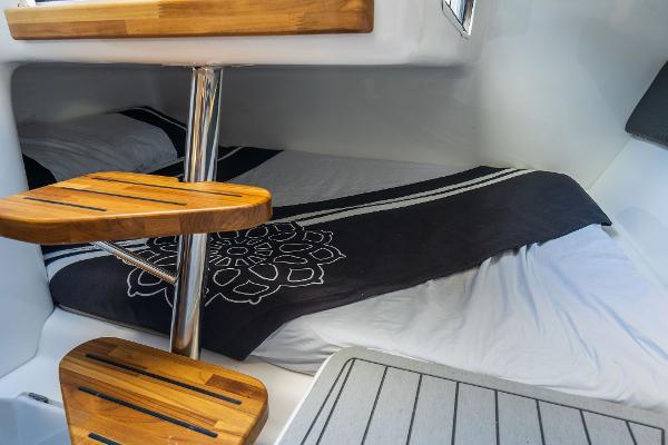 Slide: The Image of Cozy cabin interior of 2025 Hanover 305 with wooden steps and stylish bedding. - 9