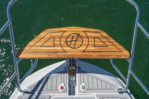 Slide: The Image of Bow view of 2025 Hanover 375 boat with teak deck and logo. - 11