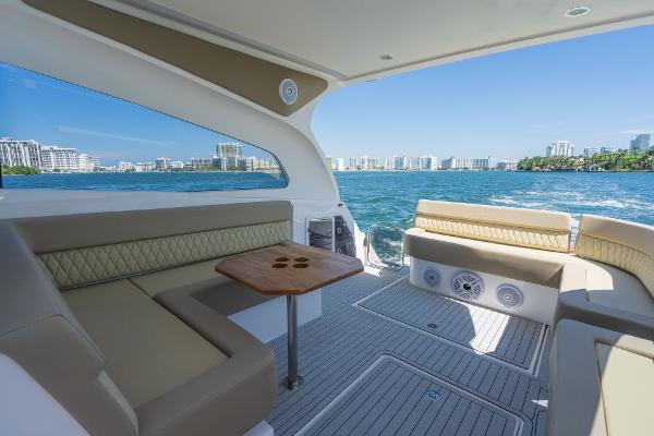 Slide: The Image of Luxurious Hanover 375 yacht interior with ocean view, featuring comfortable seating and a wooden table. - 20