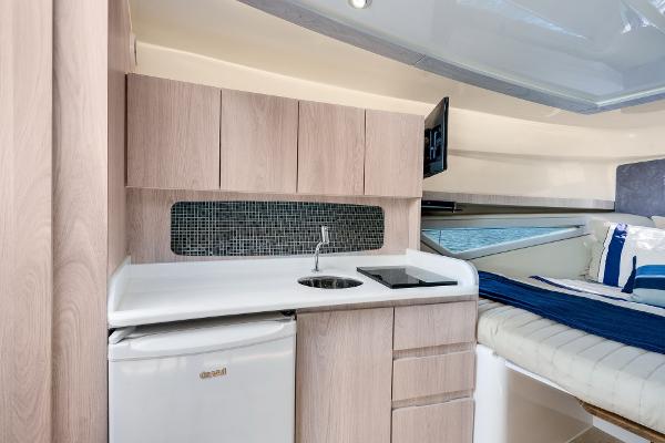 Slide: The Image of Modern kitchenette in 2025 Hanover 375 yacht with sleek cabinetry and compact appliances. - 27
