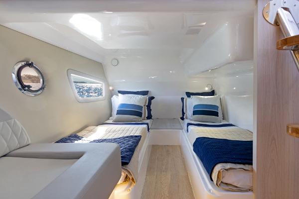 Slide: The Image of Twin beds in a modern 2025 Hanover 375 yacht cabin with nautical decor. - 28