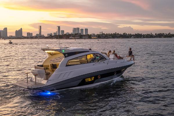 Slide: The Image of Luxury Hanover 375 yacht cruising at sunset near city skyline, 2025 model. - 30