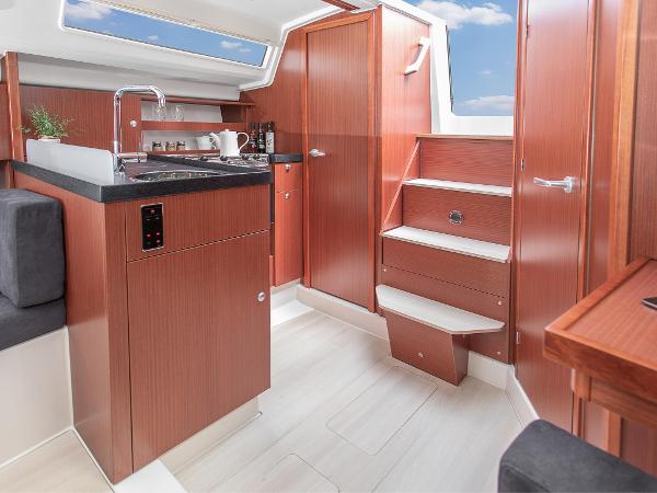 Slide: The Image of 2024 Hanse 315 yacht interior with modern kitchen and wooden cabinetry. - 11