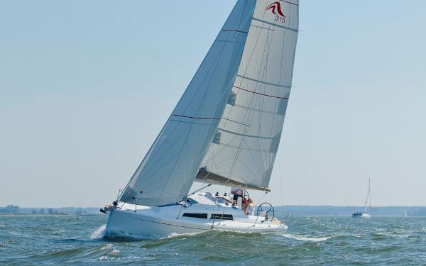 Slide: The Image of 2024 Hanse 315 sailboat cruising on open water. - 6
