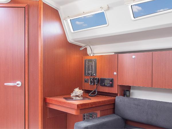 Slide: The Image of 2024 Hanse 315 yacht interior with navigation station and wooden cabinetry. - 9