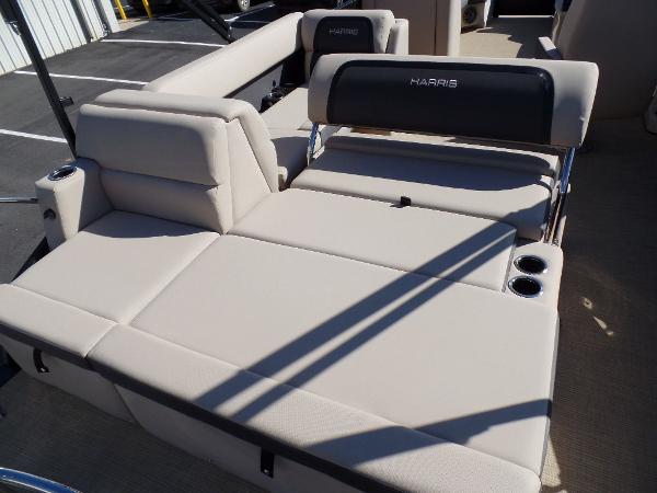 Slide: The Image of 2024 Harris Cruiser 230 boat interior with beige seating and cup holders. - 14