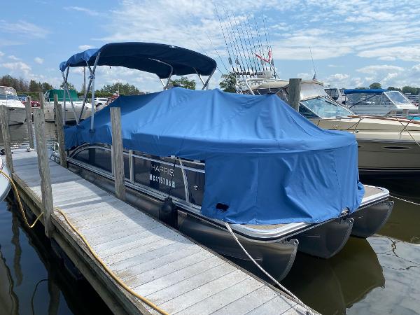 Slide: The Image of 2017 Harris 240 Cruiser pontoon boat docked with blue cover. - 0
