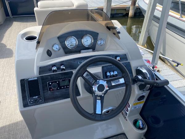 Slide: The Image of 2017 Harris 240 Cruiser boat dashboard with steering wheel and control panel. - 3