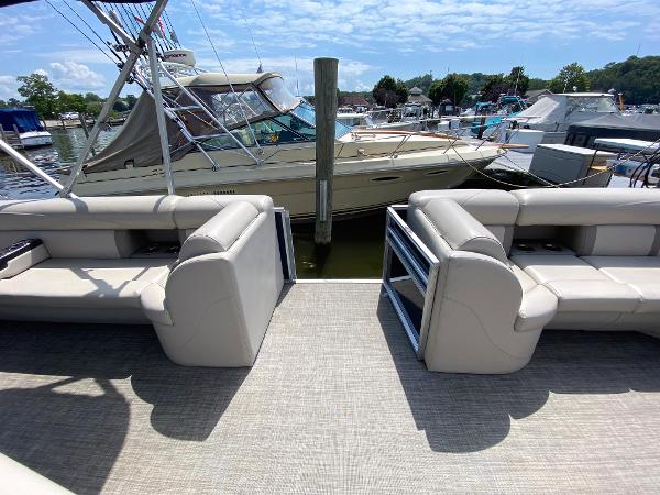 Slide: The Image of 2017 Harris 240 Cruiser pontoon boat interior at marina with beige seating. - 5
