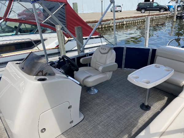 Slide: The Image of 2017 Harris 240 Cruiser boat interior with captain's chair and table. - 8