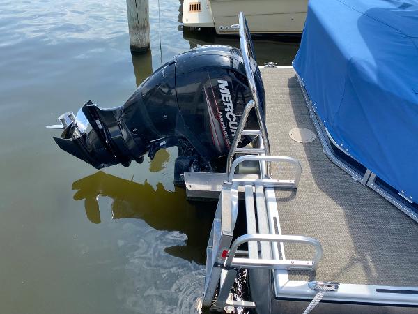 Slide: The Image of 2017 Harris 240 Cruiser with Mercury outboard motor docked. - 9