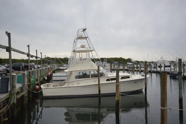 Slide: The Image of 1961 Hatteras 41 Convertible yacht docked at a marina. - 0