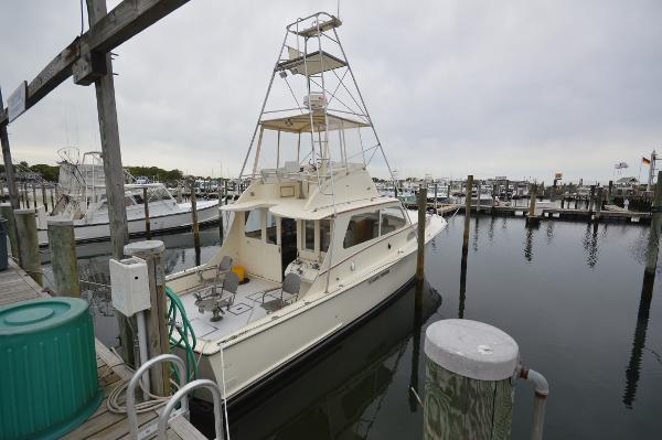 Slide: The Image of 1961 Hatteras 41 Convertible docked at a marina. - 1