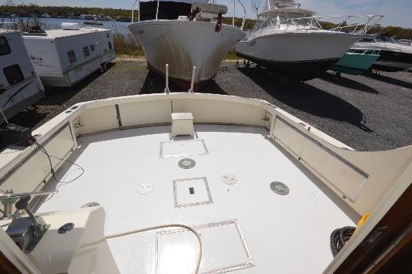 Slide: The Image of 1961 Hatteras 41 Convertible boat deck in a marina with other boats. - 12