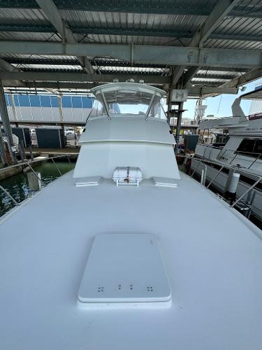 Slide: The Image of 1986 Hatteras 52 Convertible yacht docked in marina under shelter. - 10