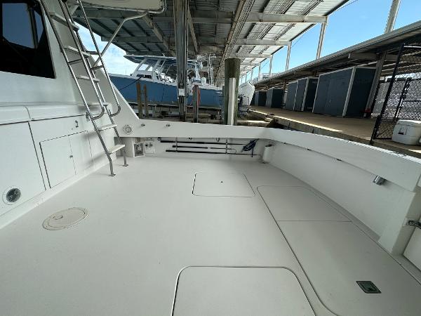 Slide: The Image of 1986 Hatteras 52 Convertible yacht deck with ladder and storage compartments. - 13