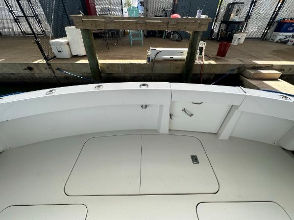 Slide: The Image of 1986 Hatteras 52 Convertible boat deck at dockside, featuring storage compartments. - 14