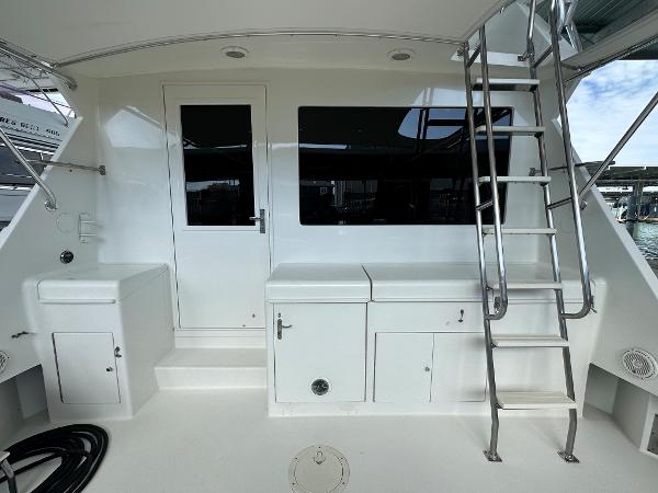 Slide: The Image of 1986 Hatteras 52 Convertible yacht deck with ladder and storage compartments. - 17