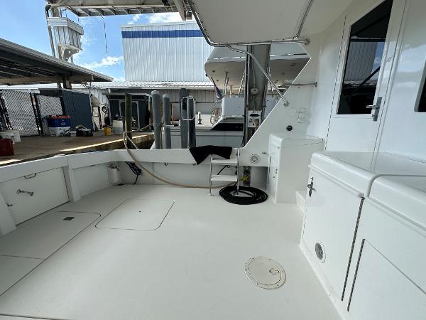 Slide: The Image of 1986 Hatteras 52 Convertible yacht deck, spacious and well-maintained, docked at marina. - 18