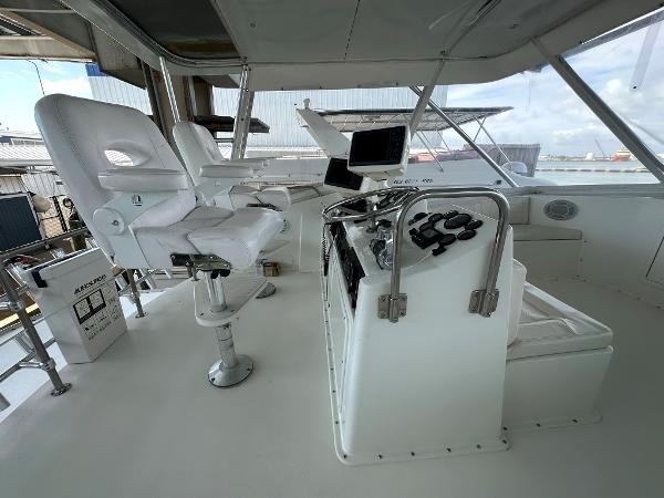 Slide: The Image of Interior helm of 1986 Hatteras 52 Convertible yacht with white captain chairs and navigation equipment. - 20