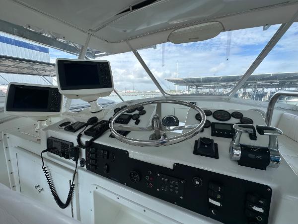 Slide: The Image of 1986 Hatteras 52 Convertible helm with modern navigation equipment and controls. - 25