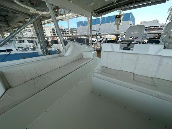 Slide: The Image of Interior of 1986 Hatteras 52 Convertible yacht with white seating and helm chairs. - 29