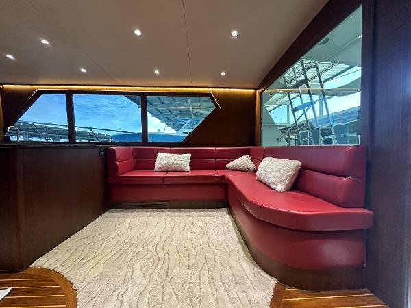 Slide: The Image of Luxurious interior of 1986 Hatteras 52 Convertible yacht with red leather seating. - 33