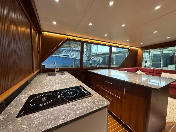 Slide: The Image of Luxurious interior of 1986 Hatteras 52 Convertible yacht with modern kitchen and seating area. - 38