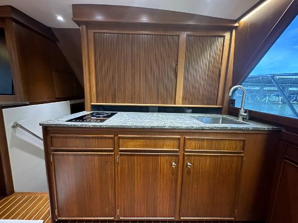 Slide: The Image of Interior of 1986 Hatteras 52 Convertible yacht with wooden cabinetry and granite countertop. - 40