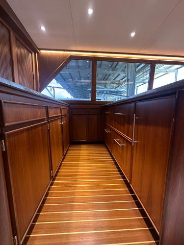 Slide: The Image of Interior of 1986 Hatteras 52 Convertible yacht with wooden cabinetry and flooring. - 41
