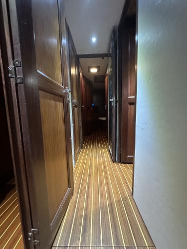 Slide: The Image of Interior hallway of 1986 Hatteras 52 Convertible yacht with wooden flooring. - 45