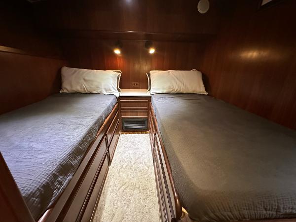 Slide: The Image of Twin cabin beds in 1986 Hatteras 52 Convertible yacht, wood paneling, cozy lighting. - 46