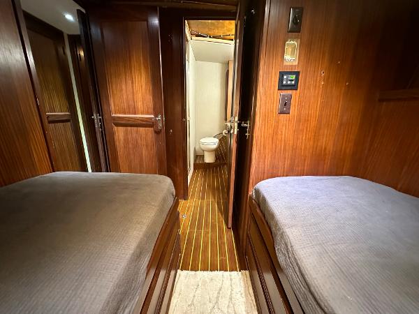 Slide: The Image of Interior of 1986 Hatteras 52 Convertible yacht with twin beds and wooden finish. - 48