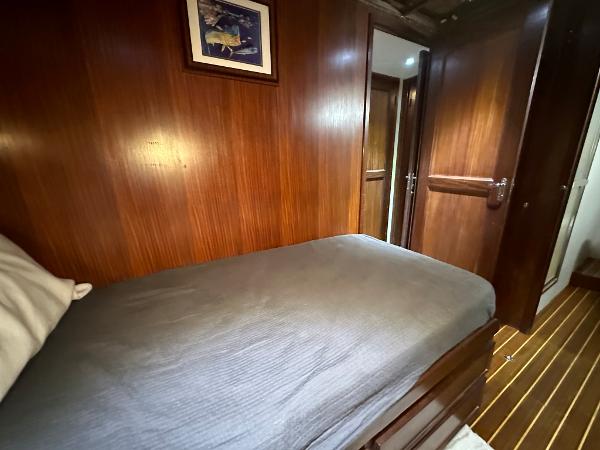 Slide: The Image of Cozy cabin interior of 1986 Hatteras 52 Convertible yacht with wooden paneling. - 49