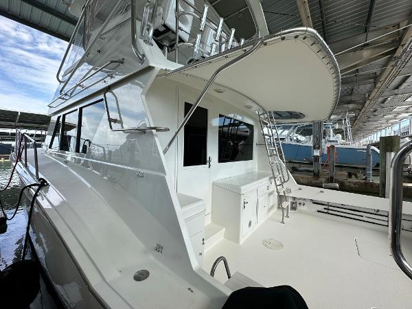 Slide: The Image of 1986 Hatteras 52 Convertible yacht docked under a covered marina. - 5