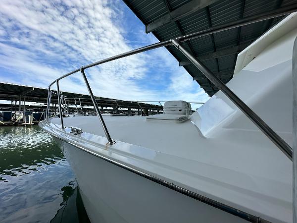 Slide: The Image of 1986 Hatteras 52 Convertible yacht docked under a covered marina. - 7