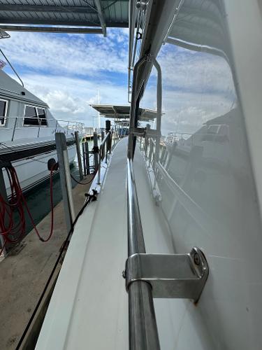 Slide: The Image of 1986 Hatteras 52 Convertible yacht docked at marina, side view. - 8