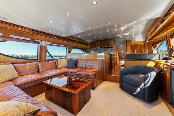 Slide: The Image of Luxurious interior of a 2007 Hatteras 64 Convertible yacht with leather seating and wooden finishes. - 1