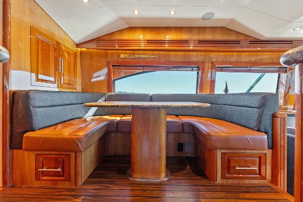Slide: The Image of Luxurious interior of a 2007 Hatteras 64 Convertible yacht with wooden finishes and leather seating. - 11
