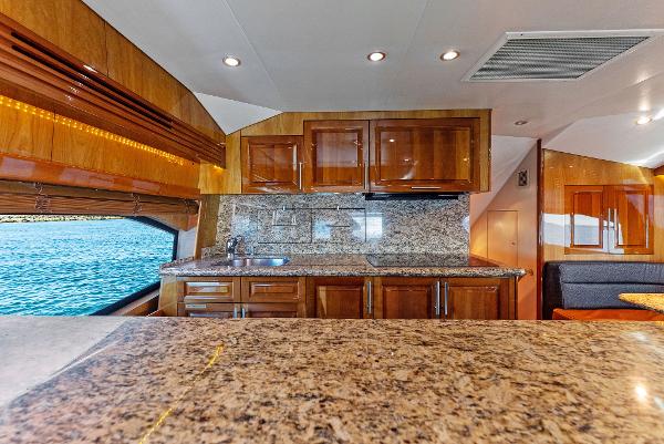 Slide: The Image of Luxurious kitchen interior of 2007 Hatteras 64 Convertible yacht with granite countertops. - 15