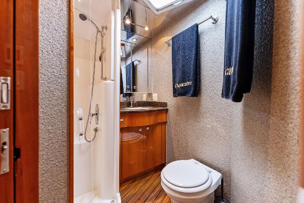 Slide: The Image of Bathroom of 2007 Hatteras 64 Convertible yacht with shower, toilet, and vanity. - 24