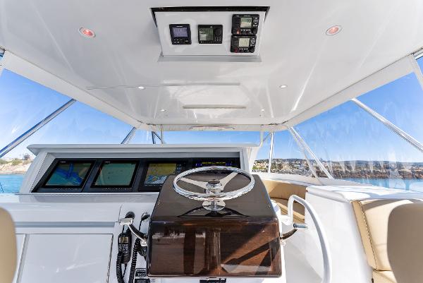 Slide: The Image of 2007 Hatteras 64 Convertible yacht helm with modern navigation equipment. - 42