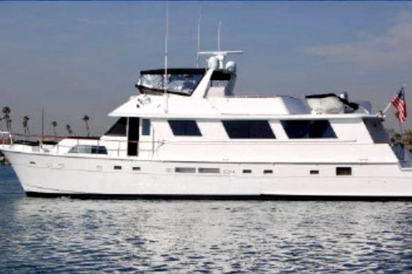 Slide: The Image of 1986 Hatteras 70' Cockpit Motor Yacht on calm waters. - 1