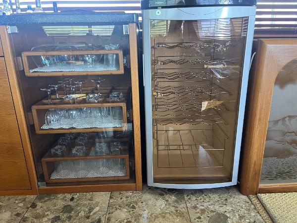 Slide: The Image of Glassware cabinet and wine cooler on a 1986 Hatteras 70' Cockpit Motor Yacht. - 19